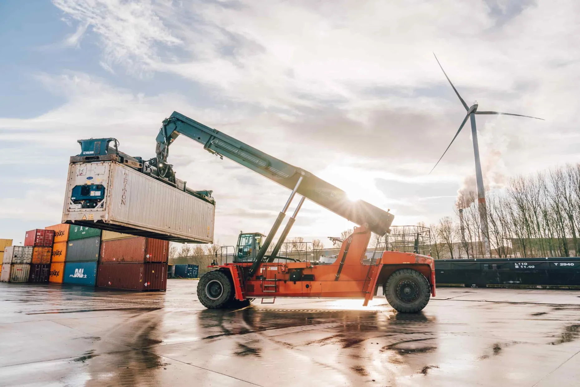 reefer_container_being_handled_by_stacker_on_terminal_banner